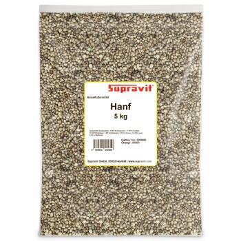 Nahaufnahme eines großen Haufens gemischter brauner und beiger Hanfsamen für Tierfutter oder Vogelfutter.