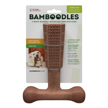 A large T-bone shaped dog chew toy made of bamboo and nylon, flavored with roast chicken, with packaging detailing its benefits.