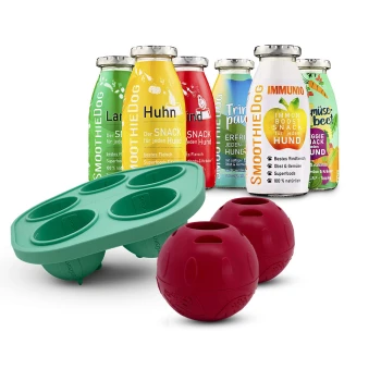 Hundesmoothie-Flaschen mit der Aufschrift 'SmoothieDog' und 'IMMUNIO', dazu eine grüne Silikon-Leckerliform und zwei rote Leckerli-Bälle
