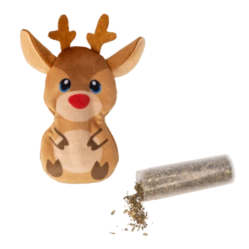 Plush reindeer dog toy with blue eyes and red nose next to a clear container spilling dried pet herbs.