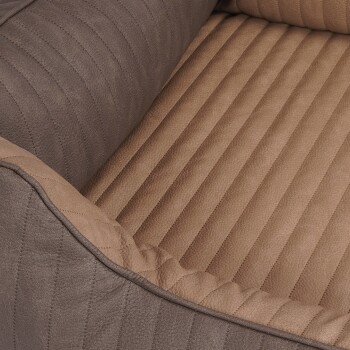 Eine Nahaufnahme eines Haustierbettes mit einem plüschigen, gesteppten Design in Braun- und Beigetönen, das seine weiche Textur zeigt.