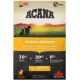 ACANA Puppy Recipe Beutel mit zwei Hunden in einem Sonnenuntergangsfeld, die 70% tierische Zutaten, 30% Gemüse und keine künstlichen Zusatzstoffe zeigen.