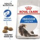 Royal Canin Indoor Long Hair cat food bag featuring a stretching long-haired cat, with text highlighting hairball reduction and adapted kibble size.