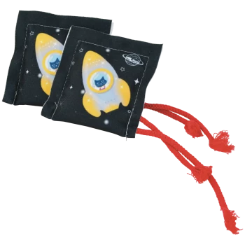 Two black square catnip toys printed with yellow rocket and cat in porthole, space stars and red braided tassels.