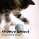 Eine verspielte Katze, die mit einem grauen Filzball auf einem Holzboden spielt, mit einem Text darunter, der "Klingender Spielspaß" und eine Beschreibung der Eigenschaften des Spielzeugs liest.
