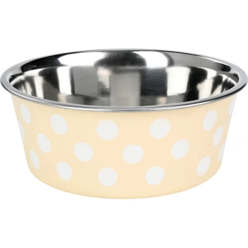 Un bol de nourriture pour animaux de compagnie beige avec des pois blancs et un intérieur en acier inoxydable brillant.