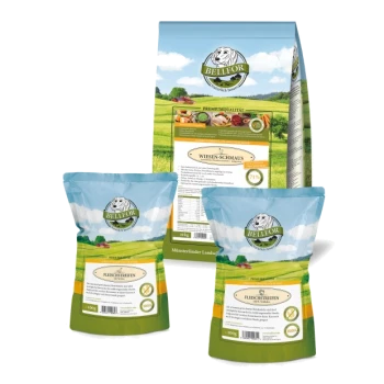 Bellfor Haustierfutterverpackung: große "WIESEN-SCHMAUS"-Tüte (71,9% Fleisch) und zwei kleinere "FLEISCHSTREIFEN"-Tüten, vor einer grünen Landschaft.