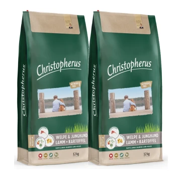 Zwei Säcke Christopherus-Hundefutter, beschriftet mit "Welpe & Junghund Lamm + Kartoffel", jeweils 12 kg schwer, mit einem Foto einer Person mit einem Hund.