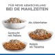 Drei Schalen mit Tierfutter: eine mit Fleisch und Gemüse, eine mit Pellets und eine mit Pellets belegt. Deutscher Text schlägt eine Mahlzeitenvielfalt vor.