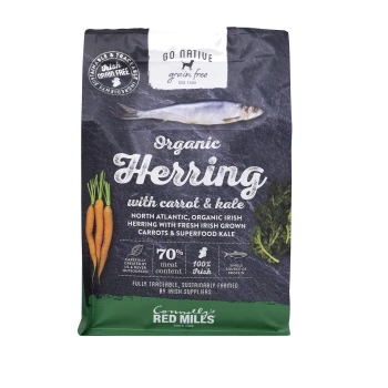 Organic herring dog food bag featuring carrots and kale, with text highlighting 70% meat content and 100% Irish ingredients.
