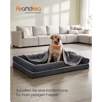 Labrador auf grauem Hundebett mit Decke und orangefarbener Halsbinde; sichtbares 'feandrea'-Logo und deutsche Bildunterschrift.