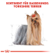 Illustration eines Yorkshire Terriers mit langem, fließendem Fell und einem roten Bogen auf dem Kopf, beschriftet mit "SORTIMENT FÜR RASSEHUNDE: YORKSHIRE TERRIER."