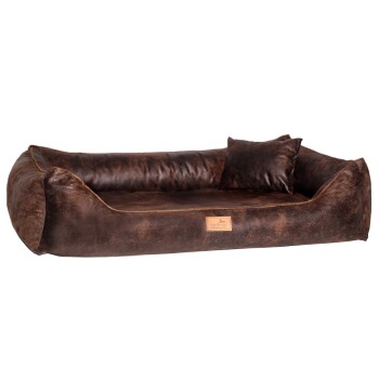 Braunes Hundebett mit einem plüschigen Design, das ein passendes kleines Kissen und ein lederähnliches Etikett mit der Aufschrift 'terland' aufweist.