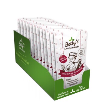 Eine Box mit Betty's Landhausküche Katzenfutterbeuteln in pinker Verpackung, beschriftet mit "Rind pur mit Bananenschal & Taurin," mit einer Kochillustration.