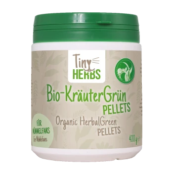 Behälter mit cdVet Bio-KräuterGrün Pellets, gekennzeichnet als 100% natürlich, für Haustiere, mit einem grünen Deckel und gelbem Hintergrund.