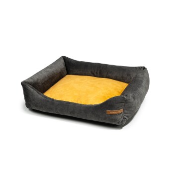 Ein gemütliches Haustierbett mit einem dunkelgrauen Außenbereich und einem weichen gelben Innenbereich, mit einem kleinen braunen Etikett an der Seite.