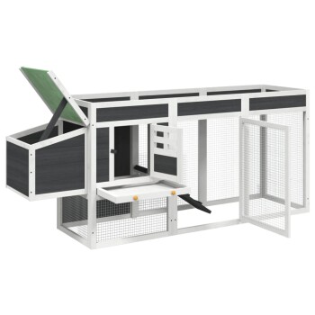 Ein geräumiger Außenbereich für Haustiere mit einem Holzdesign, mit einem schrägen grünen Dach, mehreren Zugangstüren und einer Rampe.