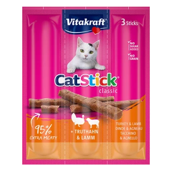 L'emballage de Vitakraft CatStick montre trois bâtonnets de viande avec une image de chat et le texte : "95 % Extra Meaty," "Sans sucre ajouté," "Sans céréales."