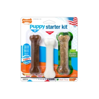 Nylabone Puppy Starter Kit with three chew bones: brown chicken, white gentle, and green bacon-flavored.