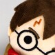 Close-up of a plush toy resembling Harry Potter with embroidered glasses and a lightning bolt scar on the forehead.