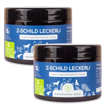 Zwei Gläser "Z-Schild Leckerli," ein Ergänzungsfutter für Hunde, mit einem blauen Etikett mit weißem Text und Illustrationen von Hunden und Pflanzen.