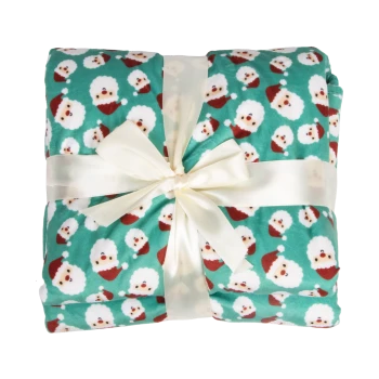 Couverture pour animal pliée couleur sarcelle avec des visages du Père Noël, attachée avec un nœud en ruban satin blanc.
