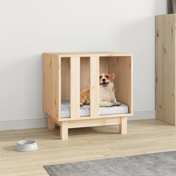Ein glücklicher Corgi sitzt in einer hölzernen Haustierbox mit einem weichen grauen Kissen, das auf einem hellen Holzboden neben einer Hundeschüssel platziert ist.