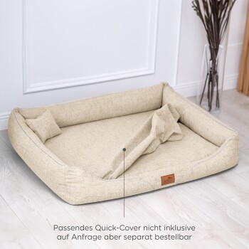 Beige Haustierbett mit erhöhten Rändern, weichem Innenraum und einem kleinen Kissen; der Text lautet: "Schnellbezug nicht enthalten, separat erhältlich."