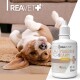 Beagle liegt auf dem Rücken auf einem Teppich neben einer Flasche mit Aufschrift 'REAVET MAGEN & DARM TROPFEN 50 ml'.