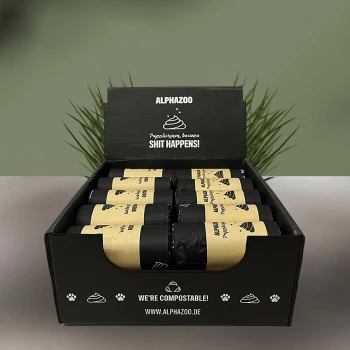 Eine schwarze Box mit der Aufschrift "ALPHAZOO" enthält Rollen mit kompostierbaren Haustierabfallbeuteln, mit dem Text "Pysztakuren, denn SCHEISSE PASSIERT!" sichtbar.