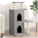 Grauer Katzenbaum mit zwei Ebenen, zwei gewölbten Eingängen und einer Seitenplattform, in einem modernen Wohnzimmer mit einer Pflanze.