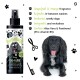 Schwarze Sprühflasche Bugalugs Zingy Cologne mit Grapefruit- & Orangenduft neben einem glücklichen schwarzen Hund mit herausgestreckter Zunge.