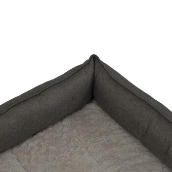 Graues Haustierbett mit plüschigem Innenraum und erhöhten Rändern, entworfen für Komfort und Unterstützung.