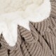 Close-up of a cozy pet bed featuring a soft, cream-colored fleece interior and textured, taupe corduroy exterior.