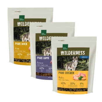 Trois sacs de nourriture pour chien "Wilderness" de Real Nature : Canard Pur, Agneau Pur et Poulet Pur, mettant en avant 65 % de viande et des images de loups.