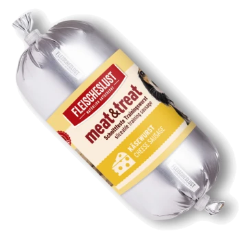 Silberne, wurstförmige Hundesnack-Verpackung mit Beschriftung "FLEISCHESLUST", "meat&treat", "KÄSEWURST" (Käsewurst) und teilweise sichtbarem Hundegesicht.