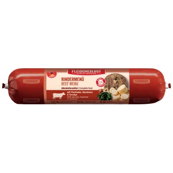 Rote Verpackung des "Fleischeslust Rindermenü" Rindermenüs für Haustiere, mit einer Fleischrolle und sichtbaren Zutaten wie Pastinake und Algen.