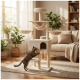 Beiger mehrstöckiger Katzenturm mit Hängematte, runden Liegeflächen und Höhle; eine getigerte Katze streckt sich in einem sonnendurchfluteten Wohnzimmer.