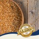 Eine Holzschüssel, gefüllt mit verschiedenen Samen auf einer Holzoberfläche, mit einem Abzeichen, das "Best Quality" und "10 Jahre" auf Deutsch liest.