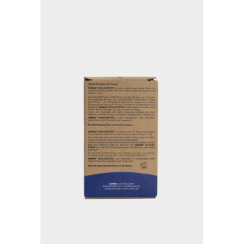 Braune Pappschachtel von Canina SCHAUMSTÜCK festem Hundeshampoo, deutscher und englischer Text, blauer Bodenbereich.
