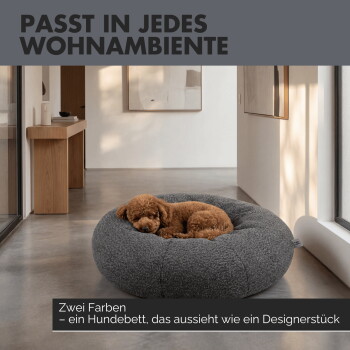 Graues rundes Hundebett mit weichem gepolstertem Rand, beschriftet mit 'Gemütliche Sicherheit' und 'Runde Donut-Form mit weicher gepolsterter Umrandung.'