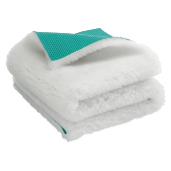 Gefaltete weiße flauschige Haustierdecke mit türkis strukturierter Unterseite, vor weißem Hintergrund gezeigt.