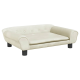 Ein stilvolles, cremefarbenes Haustiersofa mit abgerundeten Armen, Knopfdetails und einem flachen Kissen, das auf vier schwarzen Beinen ruht.