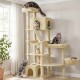 Beiger mehrstufiger Kratzbaum mit sechs Katzen, die auf Plattformen, in der Höhle und in der Hängematte faulenzen; hängendes Bommel-Spielzeug bei einem sonnendurchfluteten Fenster.