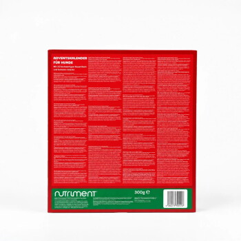 Rückseite einer roten Hunde-Adventskalender-Schachtel mit der Aufschrift 'ADVENTSKALENDER FÜR HUNDE', grünes 'Nutriment'-Etikett mit 300 g und Barcode