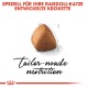 Braune dreieckige Katzenkibble mit dem Text: "SPEZIELL FÜR IHRE RAGDOLL-KATZE ENTWICKELTE KROKETTE" und "maßgeschneiderte Ernährung."