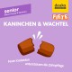 Verpackung für Senior-Hundefutter mit "Kaninchen & Wachtel" (Kaninchen & Wachtel) mit einer Grafik von zerbrochenen Kroketten und Text zur Förderung der Zahnpflege.