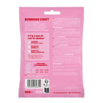 Emballage rose pour friandises pour chiots étiqueté "BONBONS CHIOT," présentant du canard et du poulet frais, riche en Oméga 3, recette sans céréales.