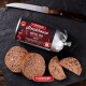 FLEISCHESLUST Steakhouse 'Büffel Pur / Pure Buffalo' Tierfutterrolle, in Scheiben geschnittene Pastetenrunden auf Schiefer mit Messer.