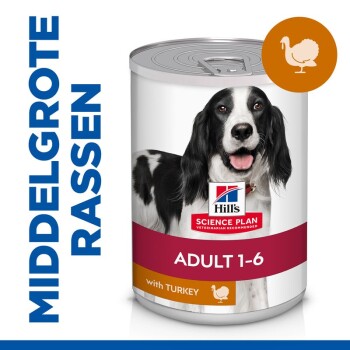 Blik hondenvoer van Hill's Science Plan, met een lachende zwart-witte hond op het etiket, gelabeld "Adult 1-6" met kalkoen.